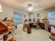 Home office featuring carpeted floors, ceiling fan, window, built-in desk and chair at 5323 73Rd N St, St Petersburg, FL 33709