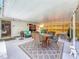 Relaxing covered patio with seating area and dining table, ideal for outdoor gatherings and entertaining at 5323 73Rd N St, St Petersburg, FL 33709
