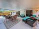 Inviting covered patio with wicker furniture and blue cushions, perfect for outdoor relaxation and dining at 5323 73Rd N St, St Petersburg, FL 33709