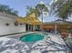 Inviting pool in backyard with sunshade, complemented by patio seating for outdoor enjoyment at 5323 73Rd N St, St Petersburg, FL 33709