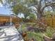 Landscaped backyard with fence, lush plants and a cozy seating area at 5323 73Rd N St, St Petersburg, FL 33709