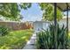 Storage shed in the landscaped backyard with privacy fence at 6304 S S Grady Ave, Tampa, FL 33616