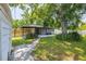 Charming home with a landscaped backyard and screened lanai at 6304 S S Grady Ave, Tampa, FL 33616