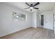 Bedroom with a ceiling fan, wood-look floors, and ensuite bathroom at 6304 S S Grady Ave, Tampa, FL 33616