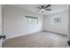 Light and airy bedroom with two windows and light wood-look flooring at 6304 S S Grady Ave, Tampa, FL 33616