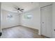 Sunny bedroom with two windows, wood-look flooring, and built-in closet at 6304 S S Grady Ave, Tampa, FL 33616