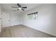 Clean, modern bedroom with wood-look floors, ceiling fan, and a built-in closet at 6304 S S Grady Ave, Tampa, FL 33616