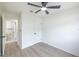 Bright bedroom featuring a ceiling fan, wood-look flooring, and ensuite bathroom at 6304 S S Grady Ave, Tampa, FL 33616