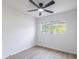Neutral bedroom with ceiling fan, light walls and flooring, and a window at 6304 S S Grady Ave, Tampa, FL 33616