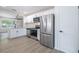 Bright kitchen featuring stainless steel appliances, granite countertops, and white cabinetry at 6304 S S Grady Ave, Tampa, FL 33616