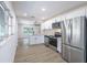 Modern kitchen featuring stainless steel appliances, granite countertops, and open layout at 6304 S S Grady Ave, Tampa, FL 33616