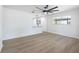 Bright living room with modern ceiling fan and windows, showcasing the beautiful flooring at 6304 S S Grady Ave, Tampa, FL 33616