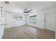Bright living room with modern ceiling fan and windows, showcasing the beautiful flooring at 6304 S S Grady Ave, Tampa, FL 33616