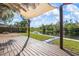 Covered wooden deck overlooking a serene waterfront, perfect for outdoor relaxation at 6814 68Th E Ave, Bradenton, FL 34203