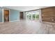 Spacious bedroom features wood floors, en suite bathroom, walk-in closet, and sliding glass doors to the exterior at 6814 68Th E Ave, Bradenton, FL 34203