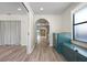 Hallway featuring hard surface floors, neutral walls, with archways leading to additional rooms at 6814 68Th E Ave, Bradenton, FL 34203