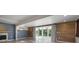 Spacious living area featuring a fireplace, sliding glass doors, and wood-accented wall at 6814 68Th E Ave, Bradenton, FL 34203