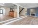 Open-concept living room with wood floors, fireplace and bar area, great for entertaining at 6814 68Th E Ave, Bradenton, FL 34203