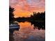 Gorgeous sunset reflections paint the sky and water with fiery hues in this scenic waterfront vista at 6814 68Th E Ave, Bradenton, FL 34203