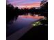 Waterfront property at dusk with beautiful lights and landscaping at 6814 68Th E Ave, Bradenton, FL 34203