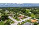Aerial shot of a home, in a neighborhood with a view of surrounding greenery at 8445 Angela Ct, Zephyrhills, FL 33541