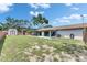 Large backyard featuring a screened porch, storage shed, and spacious grassy area, great for outdoor activities at 8445 Angela Ct, Zephyrhills, FL 33541