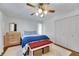 Bedroom featuring hardwood floors, ceiling fan, and closet at 8445 Angela Ct, Zephyrhills, FL 33541