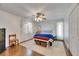 Bedroom with hardwood floors, a ceiling fan, and a window with natural light at 8445 Angela Ct, Zephyrhills, FL 33541