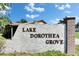 Entrance to Lake Dorothea Grove featuring a sign against a bright blue sky at 8445 Angela Ct, Zephyrhills, FL 33541