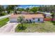 Lovely single-story home featuring a palm tree in the front yard and neutral exterior paint at 8445 Angela Ct, Zephyrhills, FL 33541