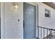 Charming home featuring a stylish blue front door with textured walls and a classic light fixture at 8445 Angela Ct, Zephyrhills, FL 33541
