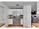 View of the kitchen featuring a stainless steel refrigerator and white cabinets at 8445 Angela Ct, Zephyrhills, FL 33541