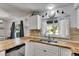 Bright kitchen featuring a double sink, white cabinets, and wood countertops at 8445 Angela Ct, Zephyrhills, FL 33541