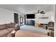 Living room with big screen television, ceiling fan and comfortable seating area at 8445 Angela Ct, Zephyrhills, FL 33541