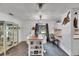 Bright living space featuring a kitchen bar and vintage cabinet at 8445 Angela Ct, Zephyrhills, FL 33541