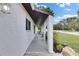 Charming covered porch with decorative columns, black and white floor tiles, and outdoor seating at 8445 Angela Ct, Zephyrhills, FL 33541