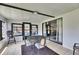 Sunroom with tile floors, comfortable seating, sliding glass doors to the outside patio, and ample natural light at 8445 Angela Ct, Zephyrhills, FL 33541