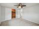Bedroom with ceiling fan, closet with sliding doors, and an adjacent bathroom with modern fixtures at 9011 Hunt Club Ln, Port Richey, FL 34668