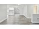 Bright and airy living room featuring modern gray flooring, neutral walls, and ample natural light at 9011 Hunt Club Ln, Port Richey, FL 34668