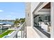 Balcony offering panoramic waterfront views, seamlessly blending indoor and outdoor living spaces at 905 Bay Point Dr, Madeira Beach, FL 33708