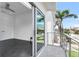 Balcony with palm tree view, accessed via sliding glass doors, with modern railings at 905 Bay Point Dr, Madeira Beach, FL 33708