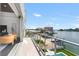 Balcony view showcases waterfront living with views of the pool, boat dock, and adjacent boat at 905 Bay Point Dr, Madeira Beach, FL 33708