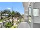 Open air balcony with sunny, clear sky and partial palm tree views at 905 Bay Point Dr, Madeira Beach, FL 33708