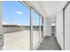 Spacious balcony with sliding glass doors, showcasing views of the water and the neighborhood at 905 Bay Point Dr, Madeira Beach, FL 33708