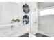 Stylish bathroom with a modern sink, artistic wall decor, and a shower at 905 Bay Point Dr, Madeira Beach, FL 33708