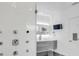 Modern bathroom featuring a sleek glass-enclosed shower with multiple showerheads and a floating vanity at 905 Bay Point Dr, Madeira Beach, FL 33708