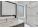 Modern bathroom featuring sleek vanity, contemporary fixtures, and tiled shower with glass door at 905 Bay Point Dr, Madeira Beach, FL 33708