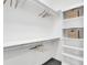 Walk-in closet with built-in shelving and hanging rods, offering ample storage space at 905 Bay Point Dr, Madeira Beach, FL 33708