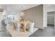 Modern dining room with stylish chairs, a sleek table, a unique light fixture, and decorative stone accent wall at 905 Bay Point Dr, Madeira Beach, FL 33708