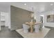 The dining area is enhanced with a light fixture and accent wall at 905 Bay Point Dr, Madeira Beach, FL 33708